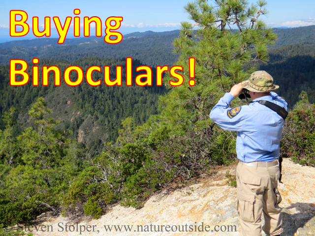 hiker on mountain using binoculars