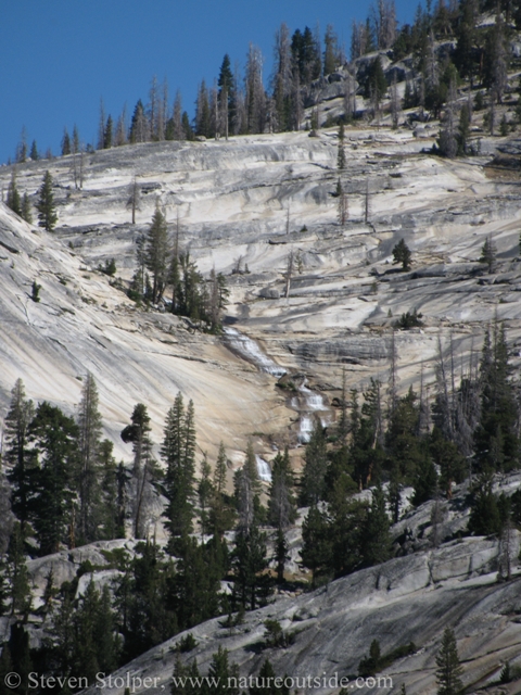 An amazing waterfall spills over granite ramparts