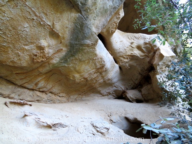 A hole in the cave floor leads through the roof of the bottom cave.