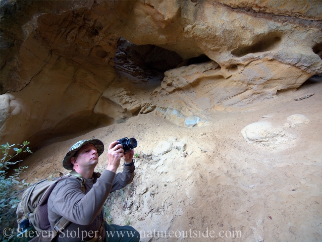 author photographing cave