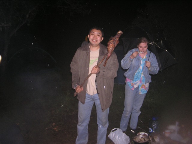 Software Engineer roasting meat over campfire