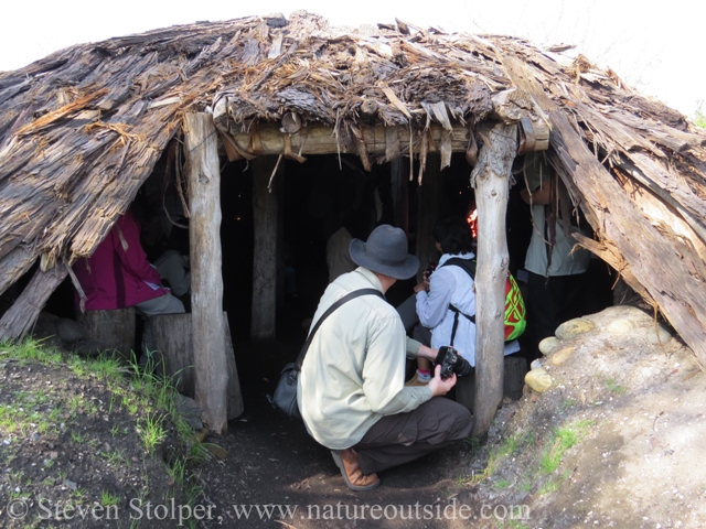 The pit house is a large structure that easily accommodates our entire group.