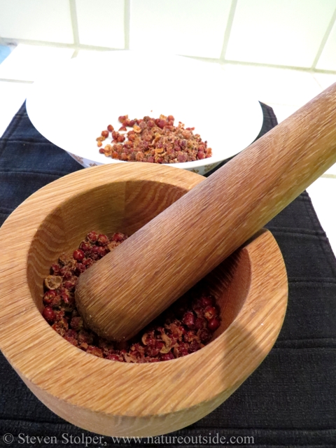 I use an inexpensive wood mortar and pestle to grind the berries.