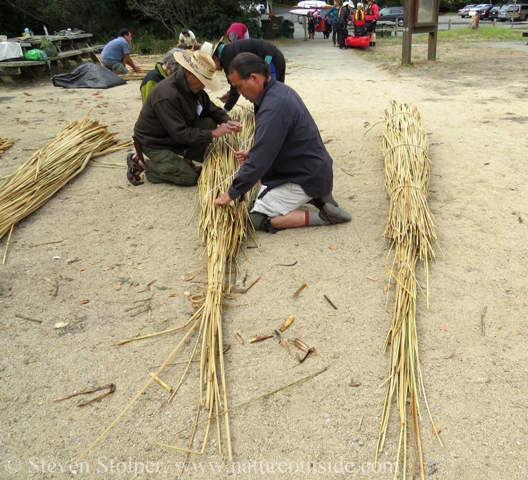 The team temporarily binds the new bundle with twine and white insulated wire.