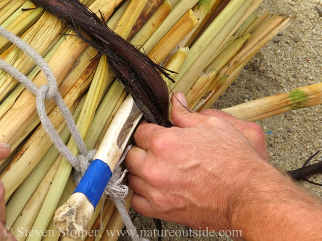 Inserting the fid makes space between the tule and the grapevine. The vine is fed underneath itself into the fid. I like to pin the vine against the fid with my thumb and pull them both at once.