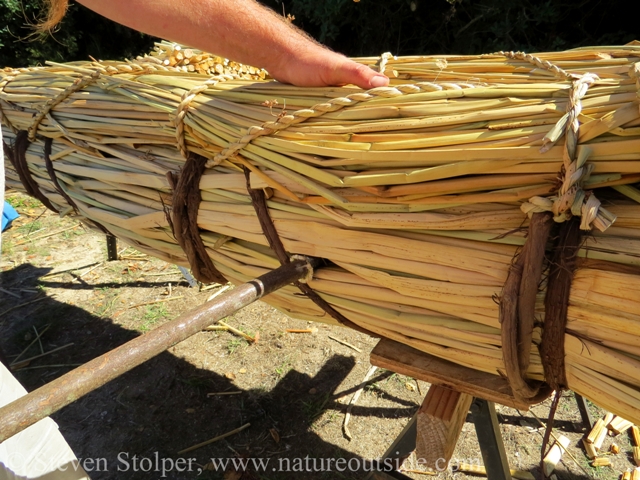 We used a second hazel rod to push the first completely inside the boat.