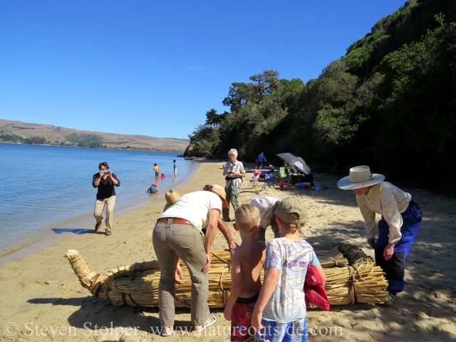 Preparing the boat draws interest from the crowd.