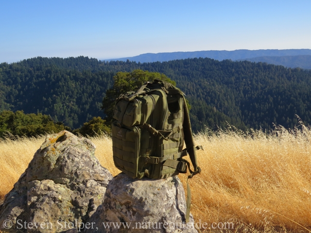 backpack and mountains in hot weather
