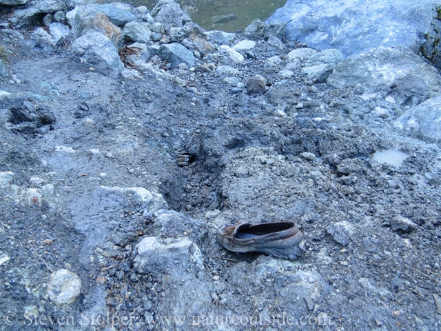 two shoes stuck in mud