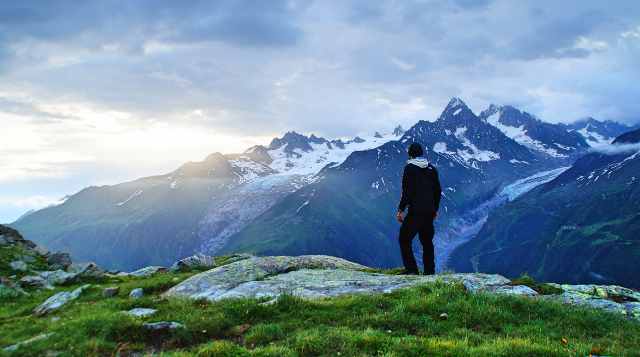 man looking at glacier