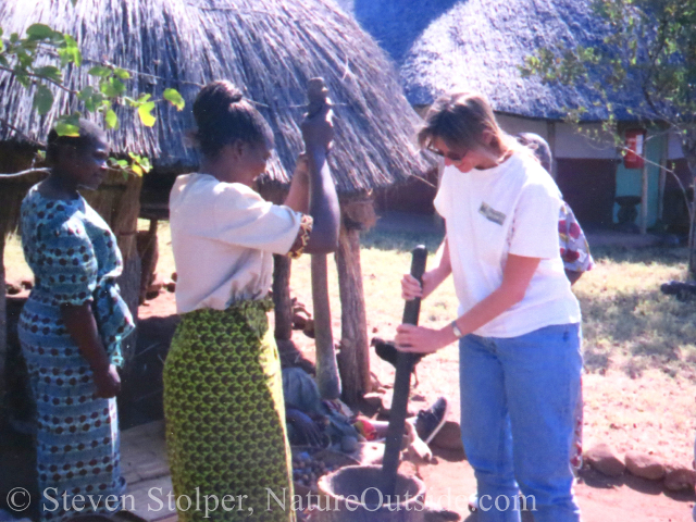 grinding grain. Songwe Point village, Azmbia