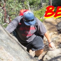 hiker climbing rock face title