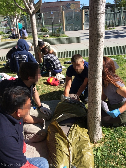 wilderness first aid students examine patient