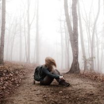 woman hiker sitting on trail