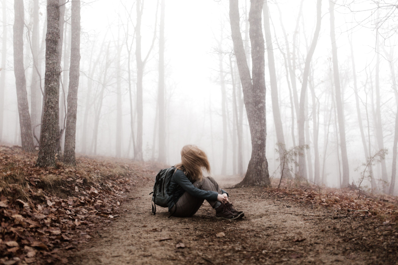 woman hiker sitting on trail