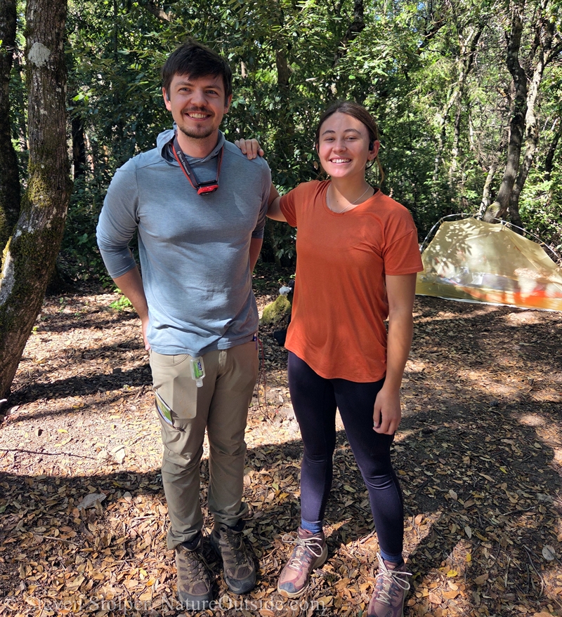 two backpackers at camp