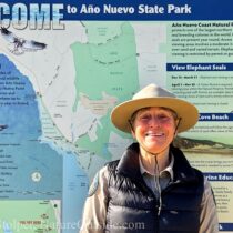 nature interpreter in front of sign