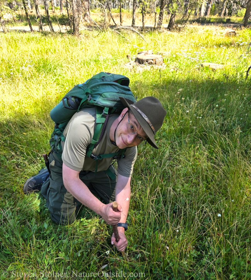 man using digging stick